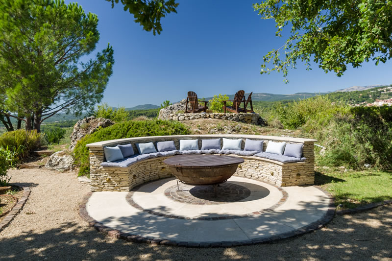 Stone seating round fire pit and sunset viewing deck